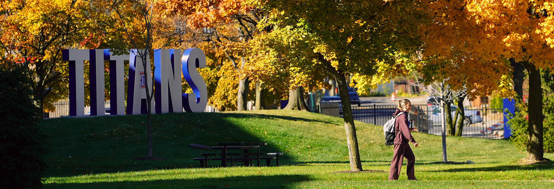 A student walks past the TITAN sign during the fall.